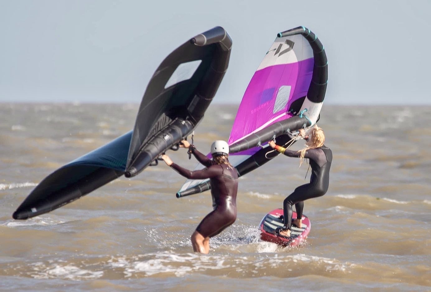 Two beginners learning to handle the wing on the Essex coast