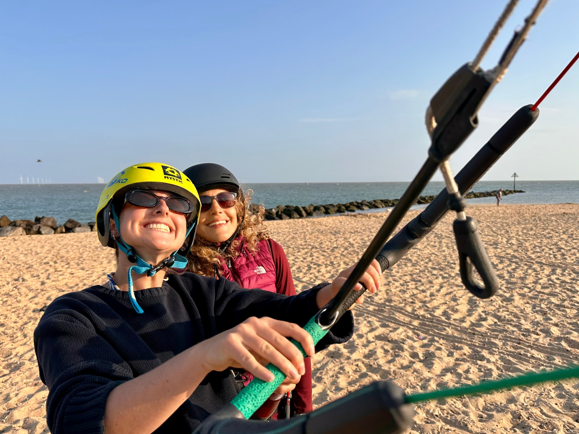 Beginner student learning to fly a kitesurfing kite on the beach at Martello Bay in Essex with a Zenith Kiting IKO instructor