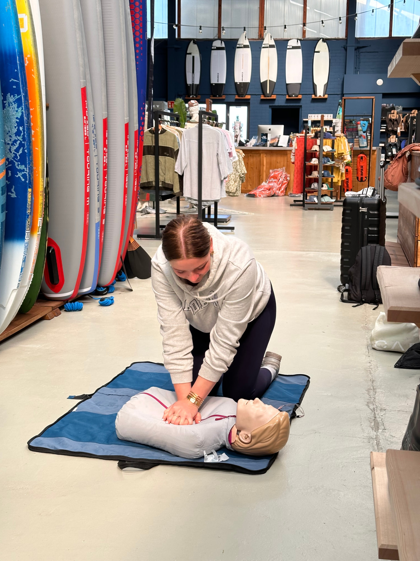 Student performing CPR on a manikin during a practical scenario
