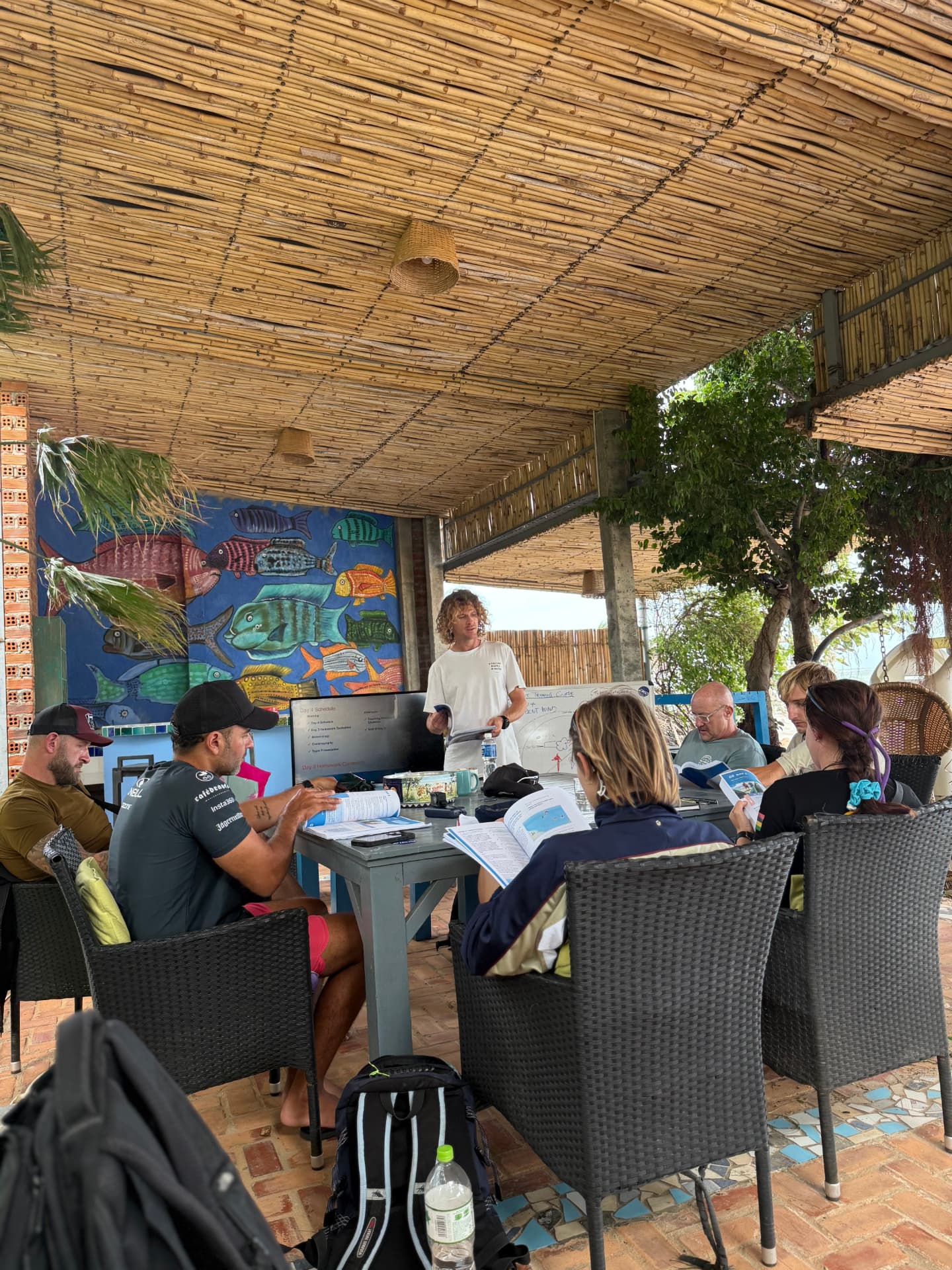 Instructor candidates in a theory session with course workbooks