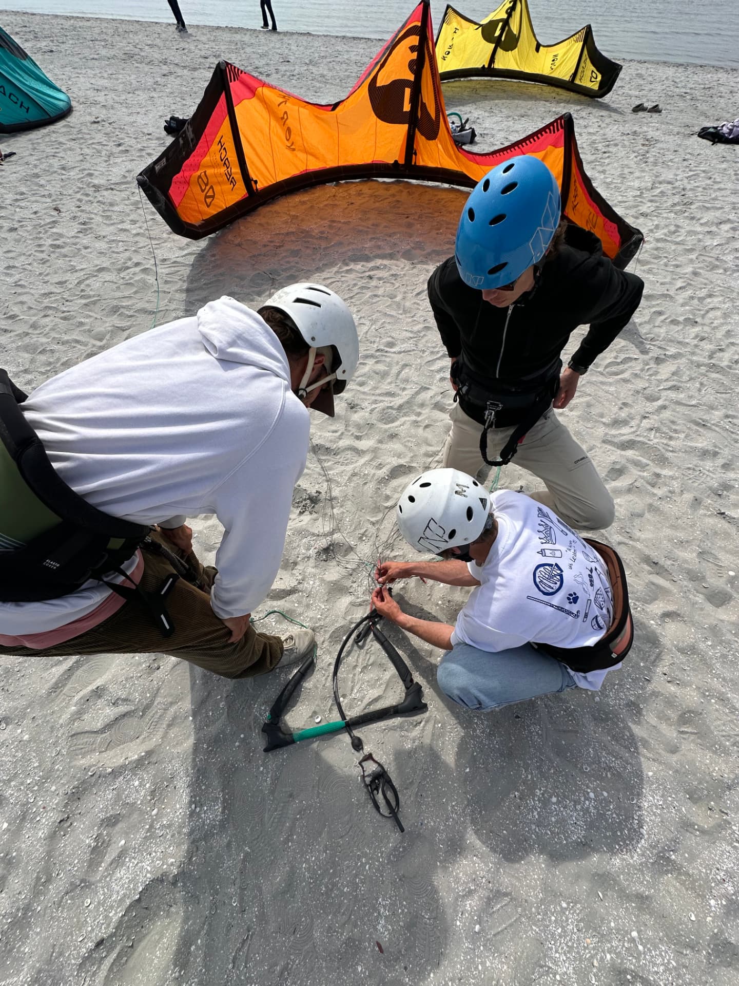 Candidates practising rigging lines and equipment set-up on the sand