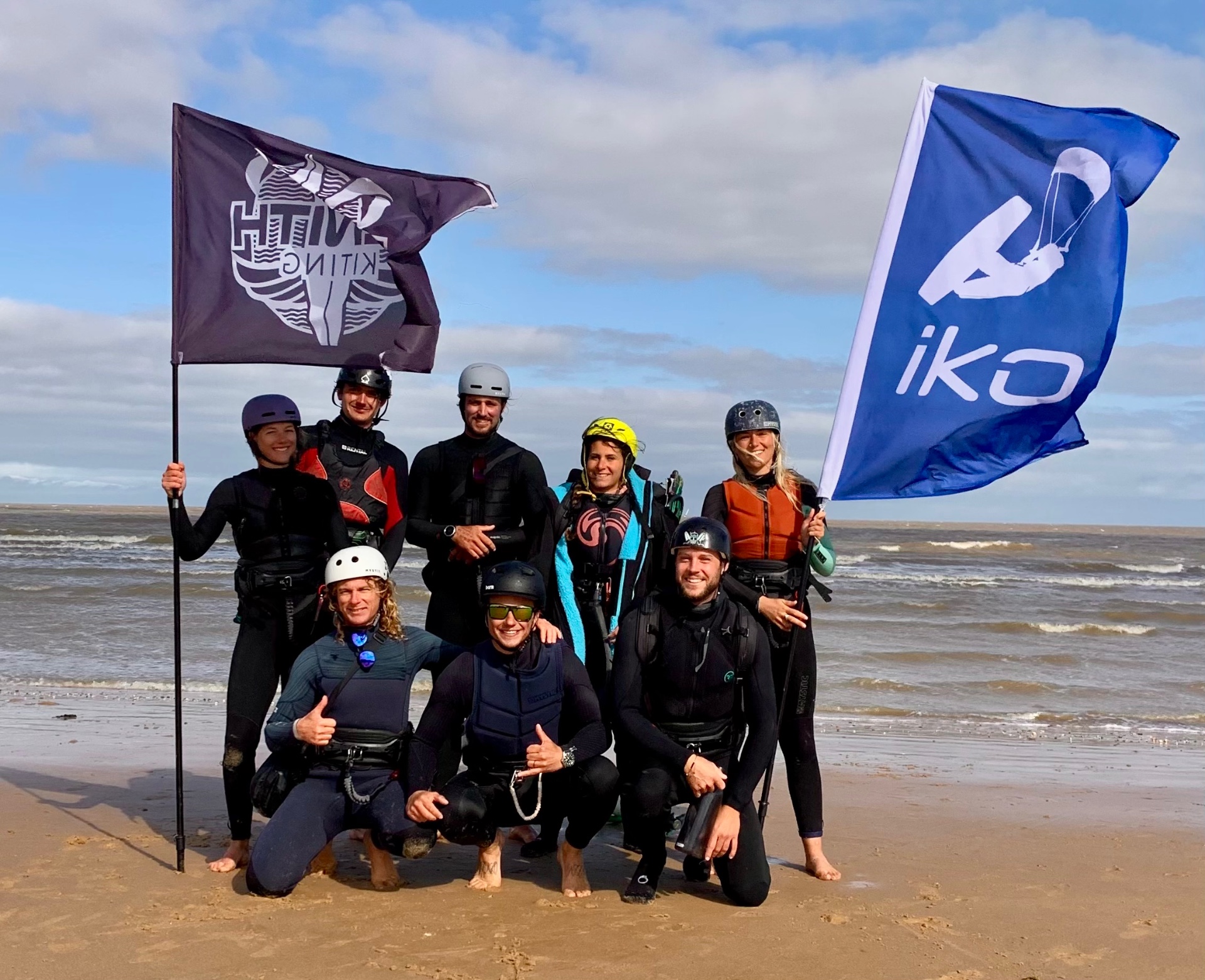 Zenith Kiting instructors and students on the beach at Martello Bay with IKO and Zenith Kiting flags