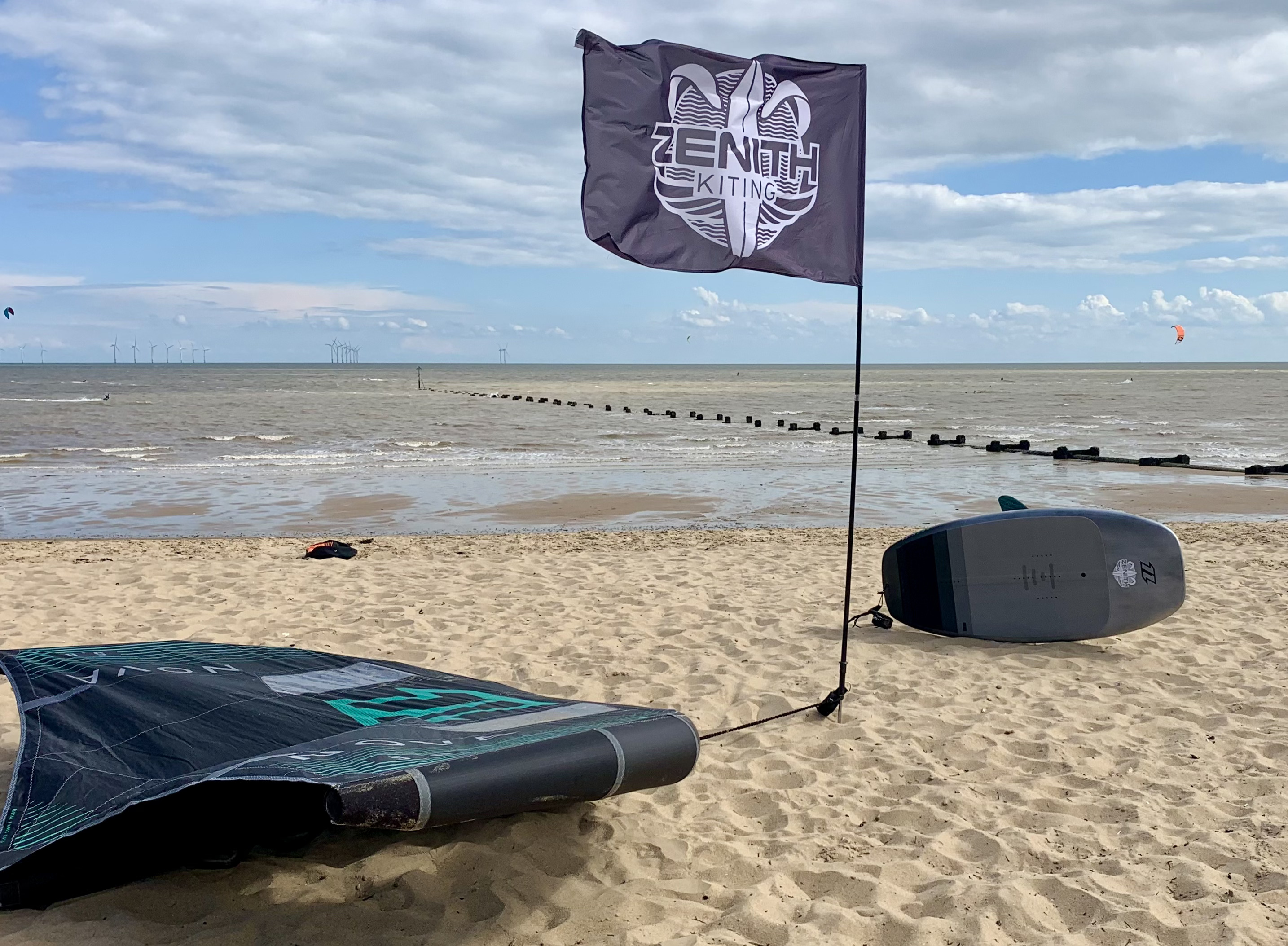 Zenith Kiting flag on the beach with North wing and foil board