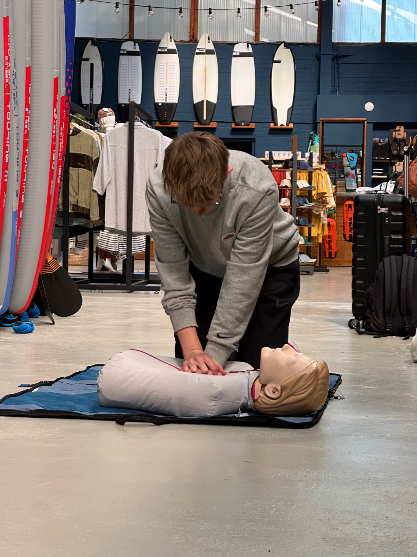 Candidate practising chest compressions on a CPR manikin